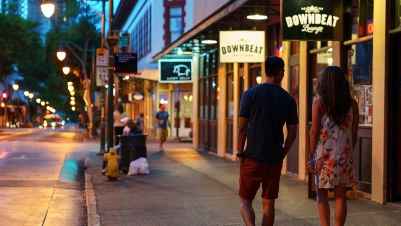 couple shopping at night in chinatown (honolulu)